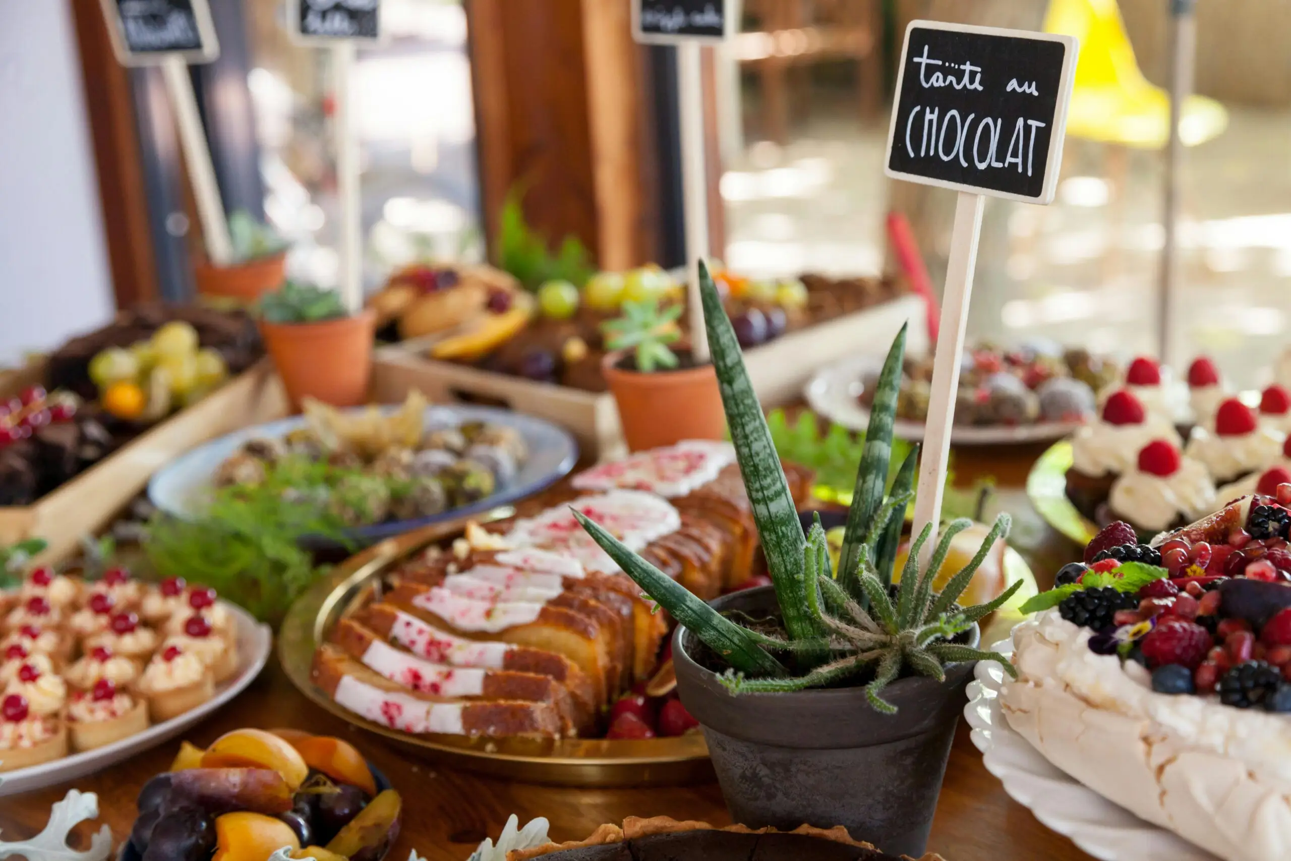 A vibrant spread of assorted pastries and cakes displayed on a dessert table for special occasions.